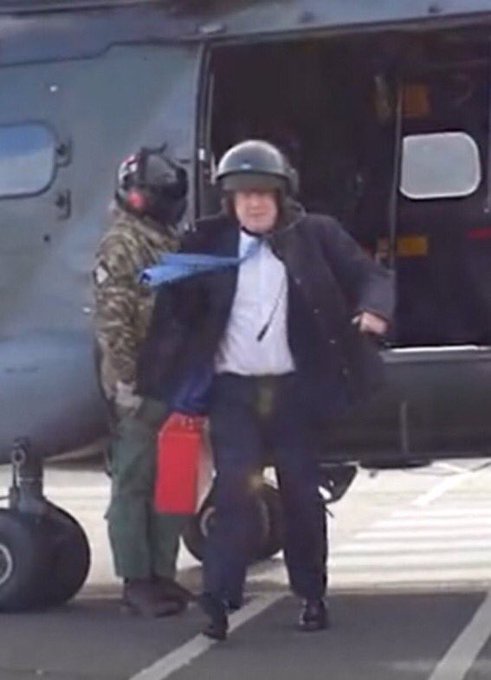 Untidy Johnson leaving a helicopter